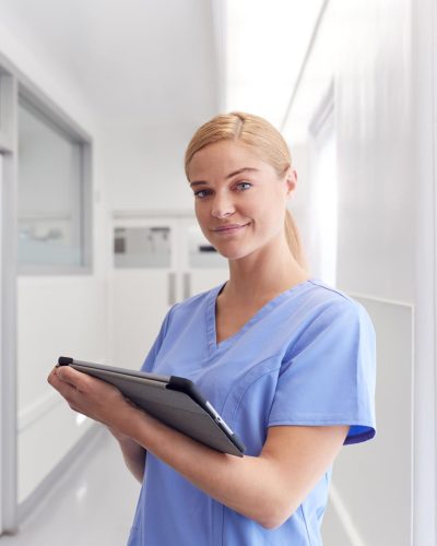 portrait-of-smiling-female-doctor-wearing-scrubs-EYSJKTB-1.jpg