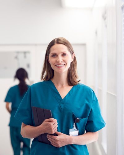 portrait-of-smiling-female-doctor-wearing-scrubs-HZ79GZQ-1.jpg